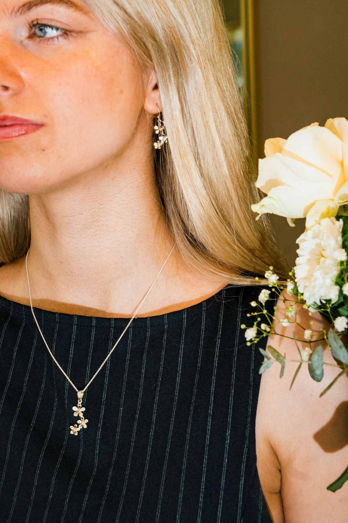 Model wearing a Griffin and Co necklace and earrings