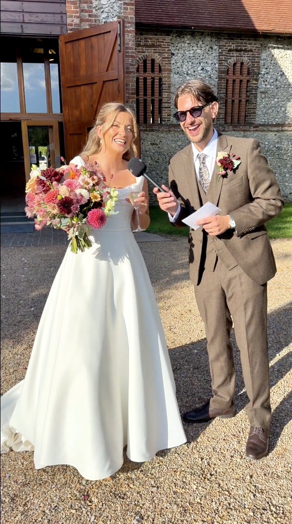 Bride being interviewed with a microphone outside the venue