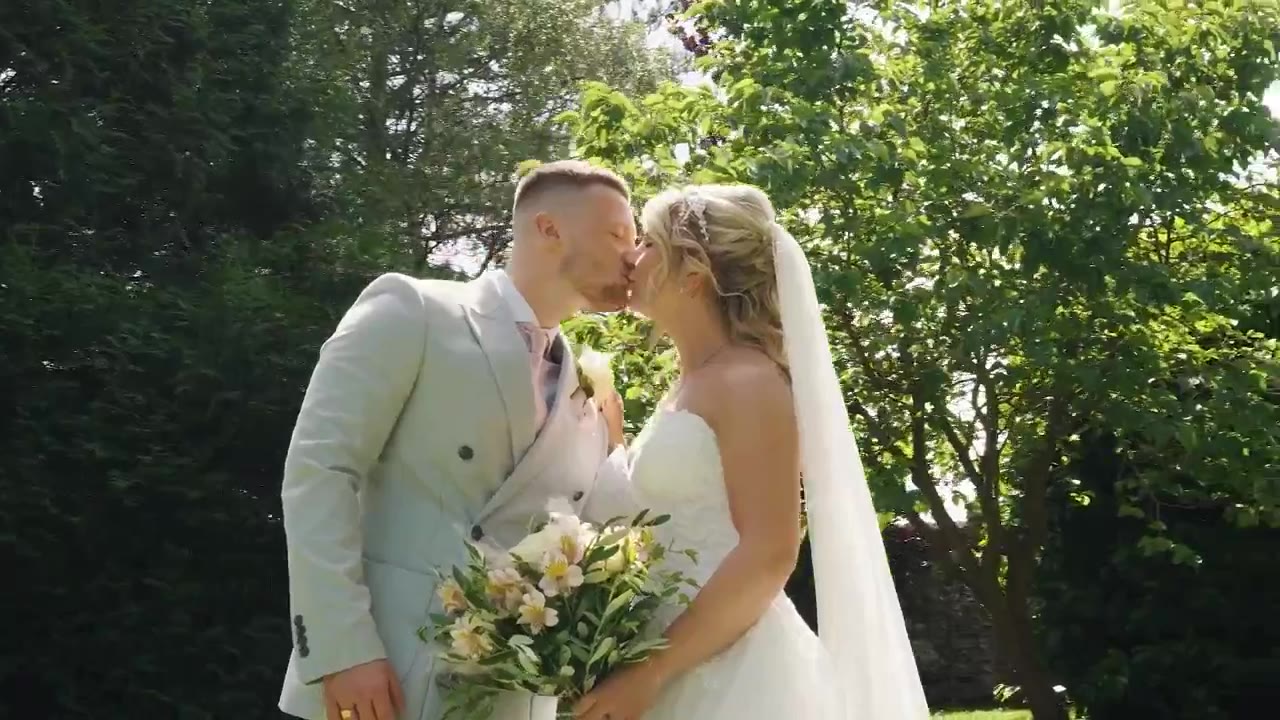 Matt and Maddie kissing in the garden on their wedding day