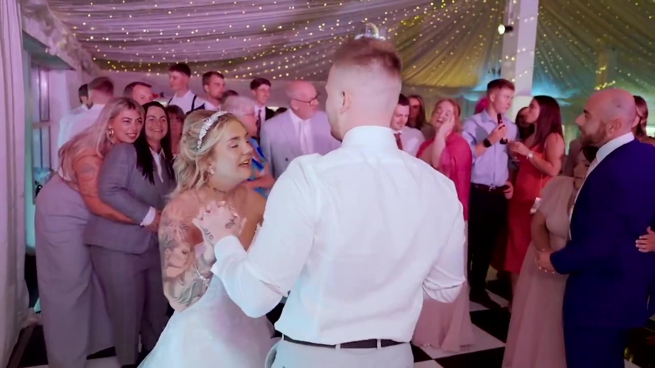 Bride and groom dancing with guests